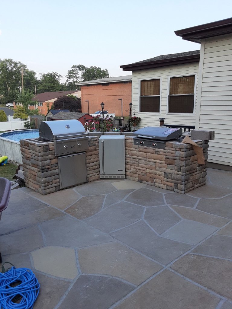 Custom outdoor kitchen with stone veneer